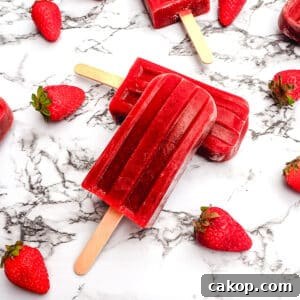 Strawberry balsamic popsicles with fresh strawberries.