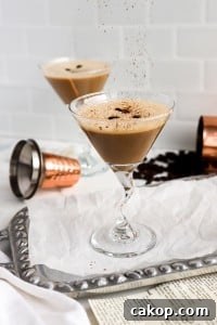 front facing view of classic espresso martini with shaker cup in background