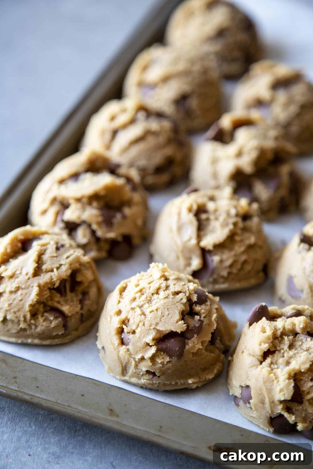 Chewy Milk Chocolate Chip Cookies Recipe for Perfect Cookies 8 Cookie dough balls on a baking sheet.