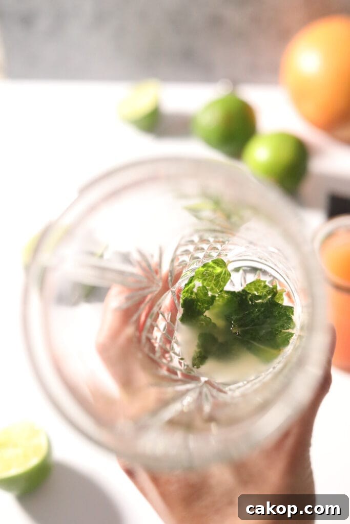 Muddled mint leaves in a cocktail shaker.