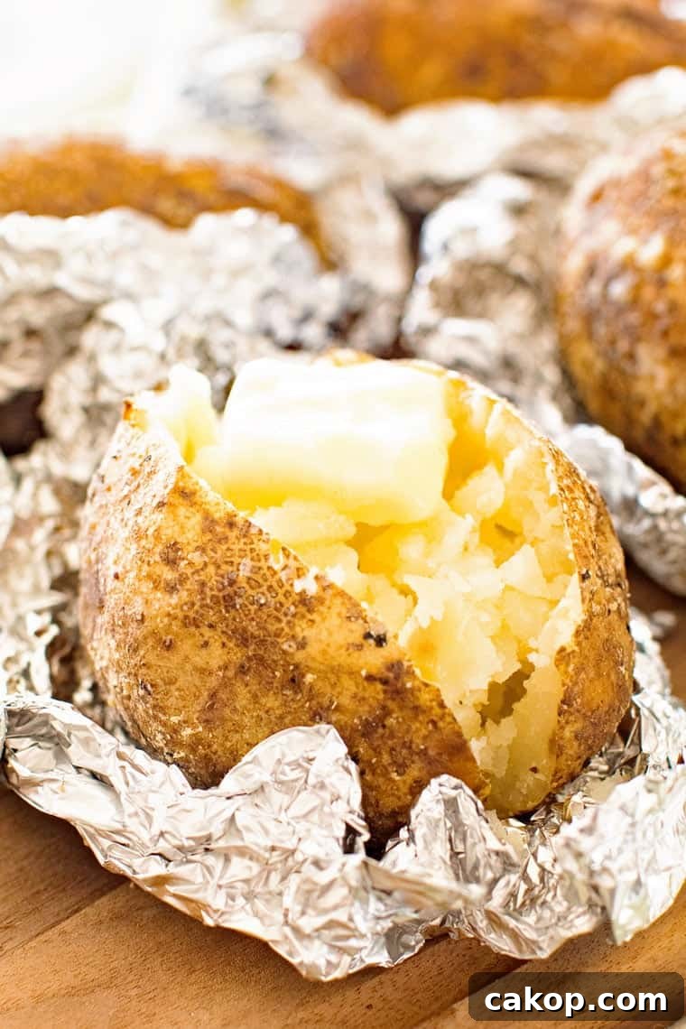 baked ptoatoes cut up with butter