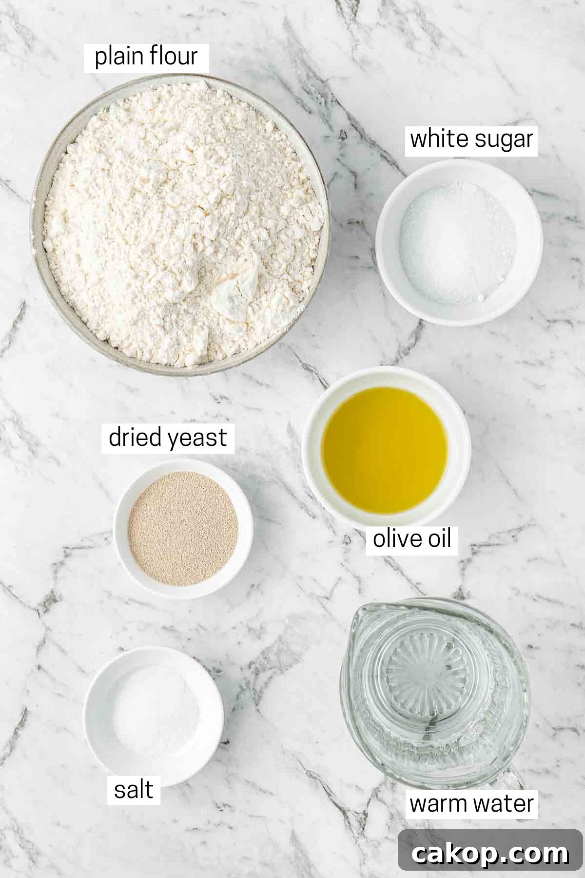 All ingredients needed to make pizza dough laid out in small bowls.