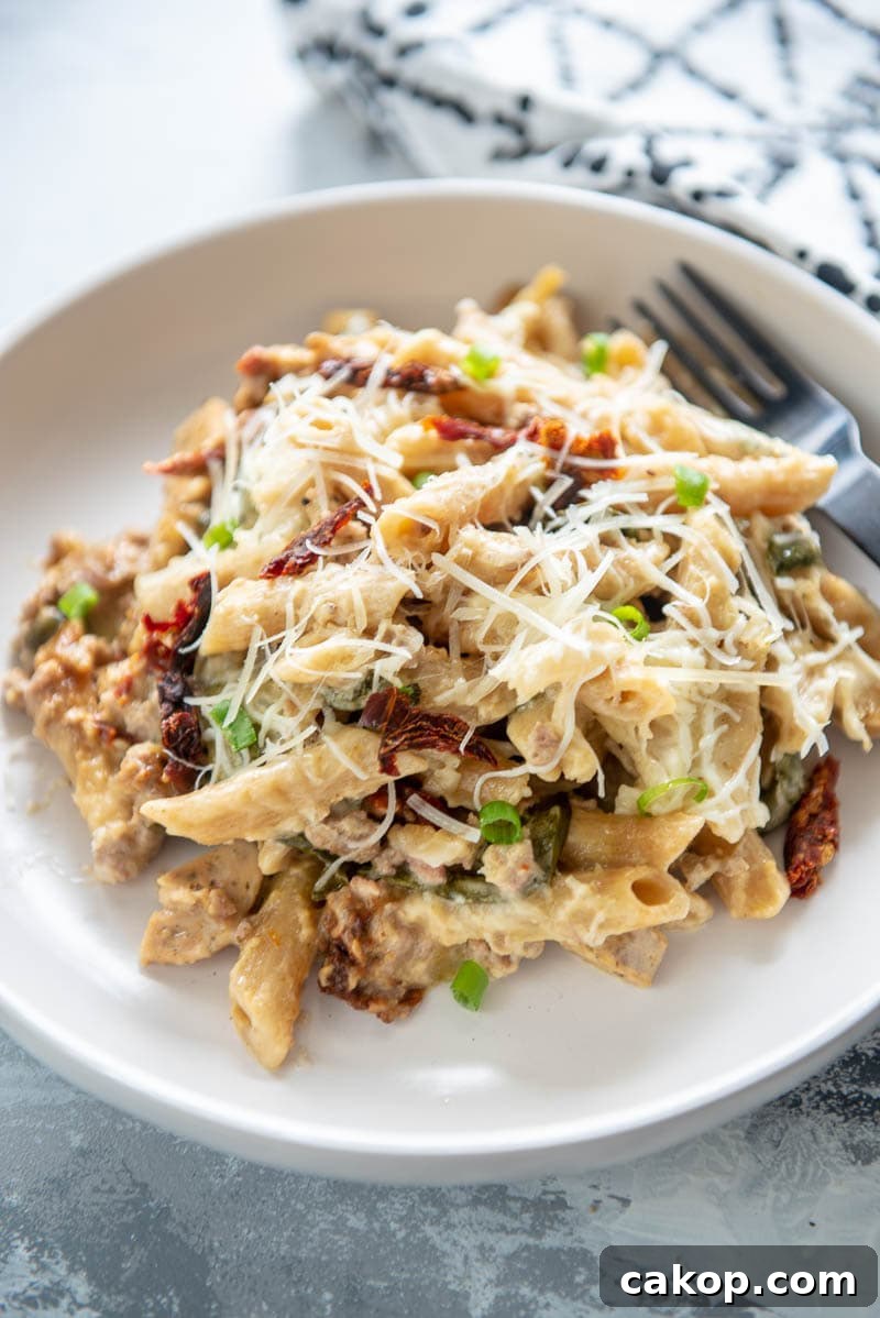 slow cooker sausage pasta bake on a plate with fork