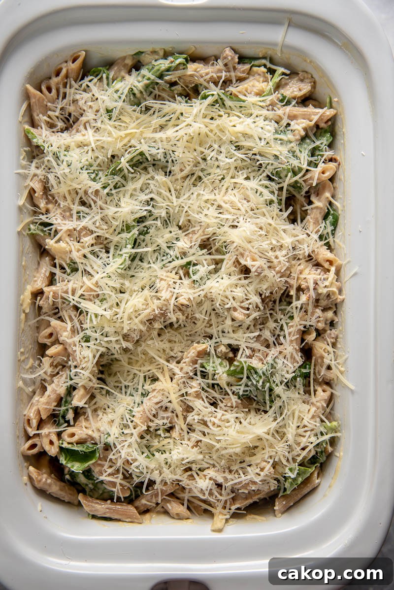 ingredients for sausage pasta bake mixed together in a slow cooker