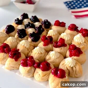 patriotic American flag dessert with red, white and blue topping on biscuits.