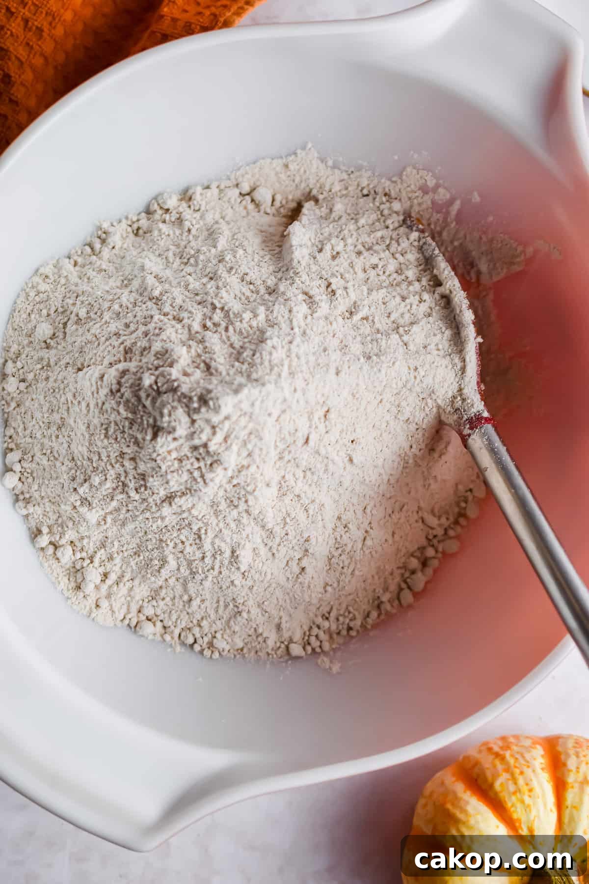 2-Ingredient Pumpkin Spice Muffins — Quick Autumn Recipe 5 The dry cake mix is added to the bowl.
