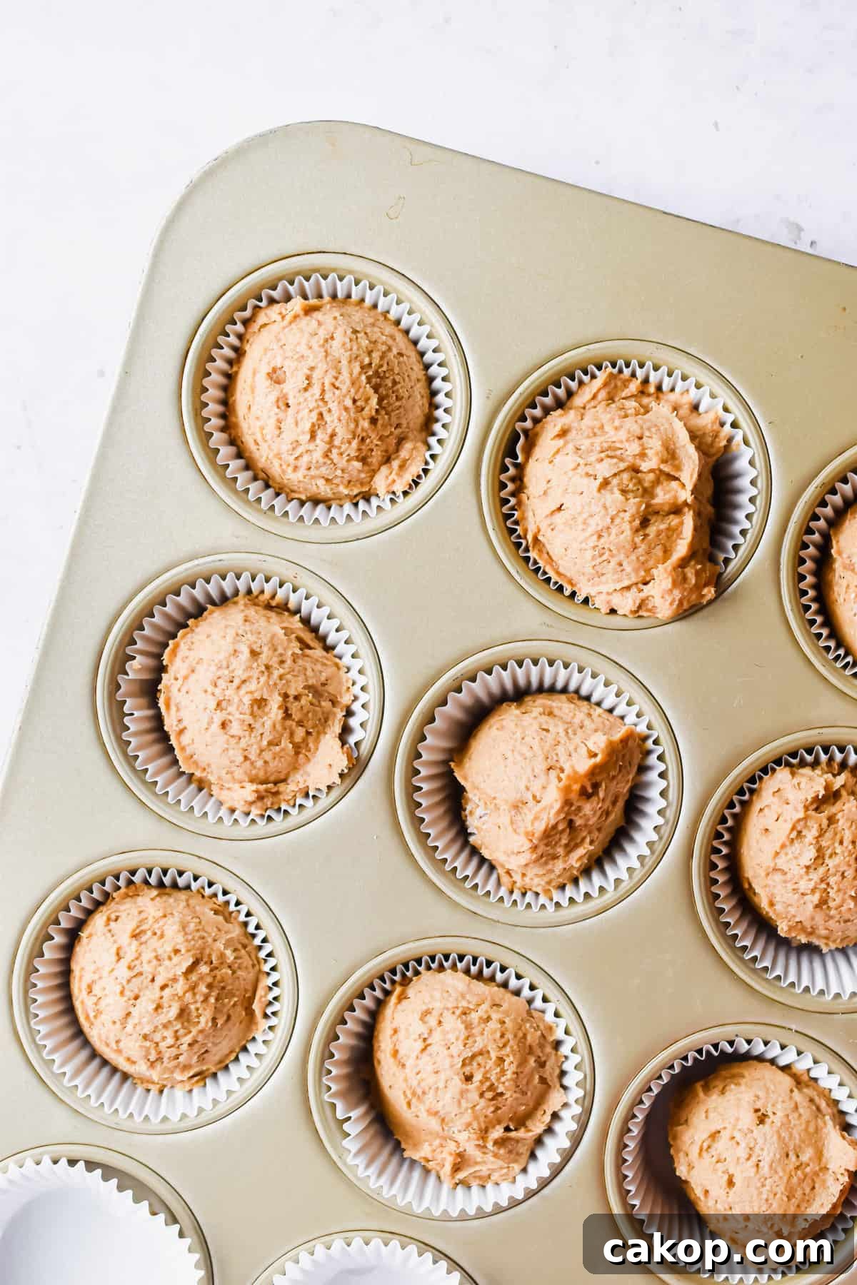 2-Ingredient Pumpkin Spice Muffins — Quick Autumn Recipe 7 The batter is in the muffin tray.