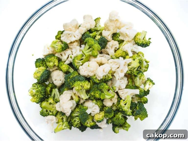Step 1 Chopped broccoli and cauliflower florets in mixing bowl for healthy broccoli cauliflower salad.