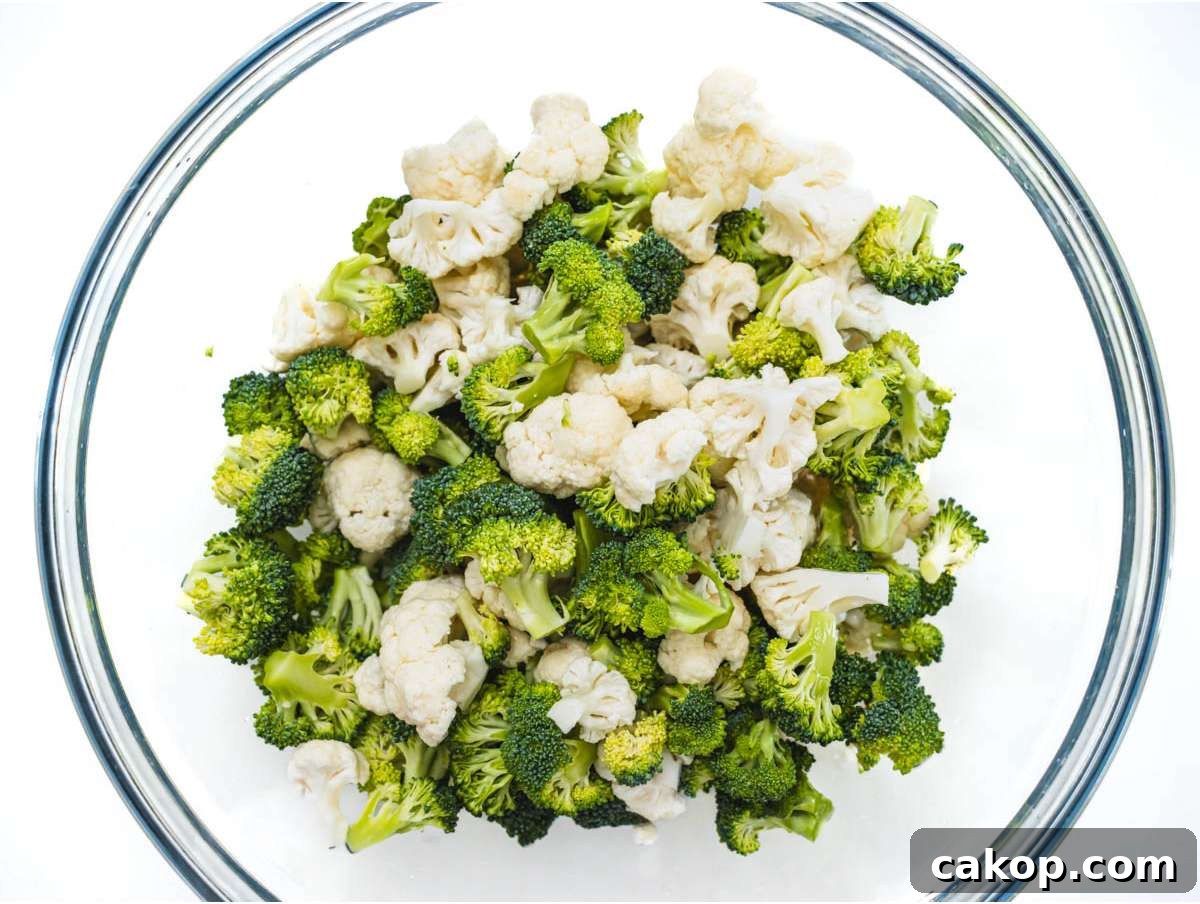 Step 1 Chopped broccoli and cauliflower florets in mixing bowl for healthy broccoli cauliflower salad.