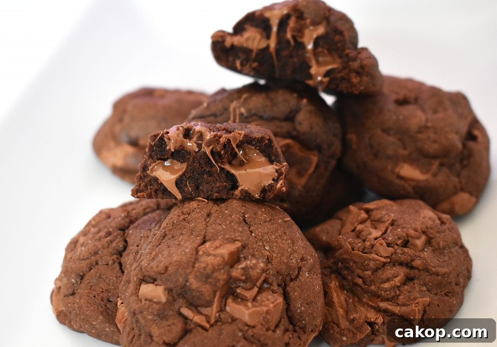 Ultimate Chocolate Chunk Cookie Recipe for Perfect Chewy Cookies 7 Pile of double chocolate cookies on a white plate.