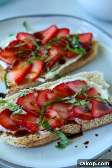 Strawberry ricotta toast topped with basil and balsamic.