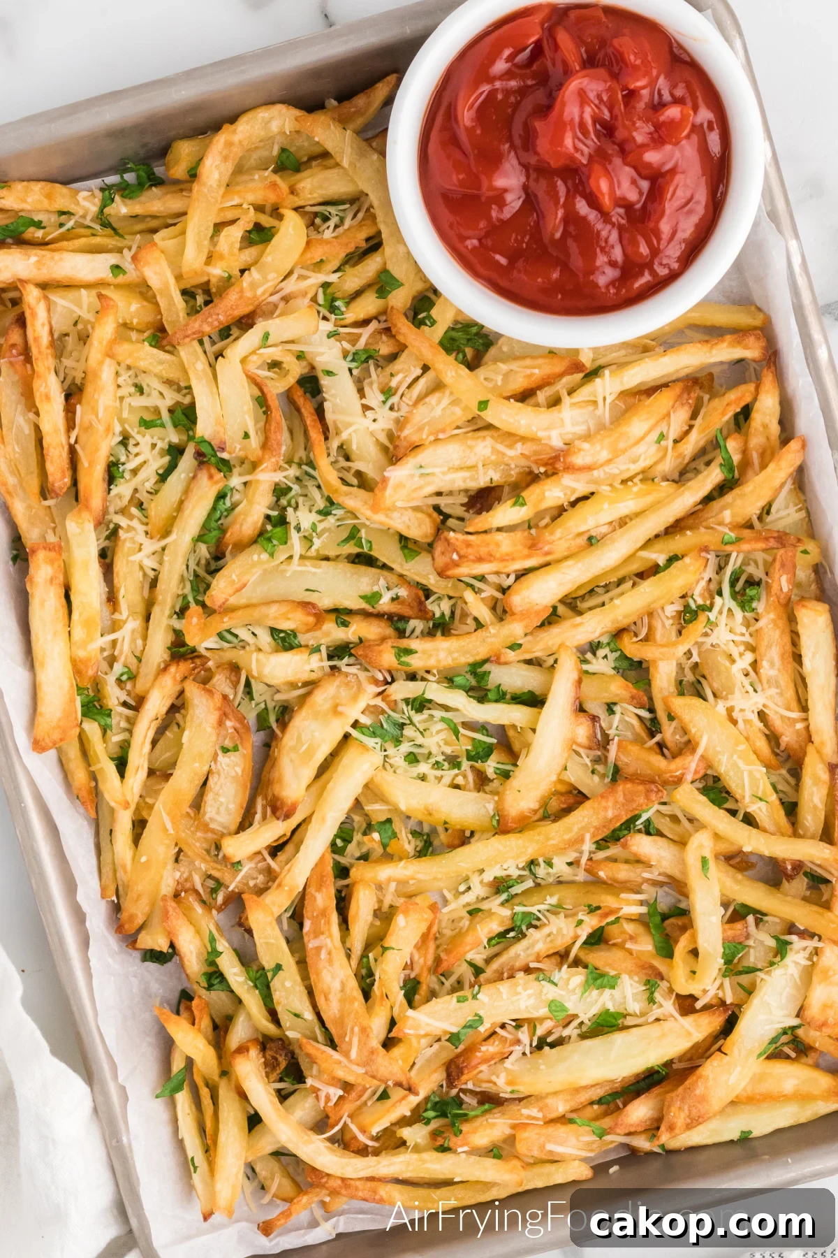 Crispy Air Fryer Truffle Fries Recipe 5 Truffle fries on a serving platter with a side of ketchup.