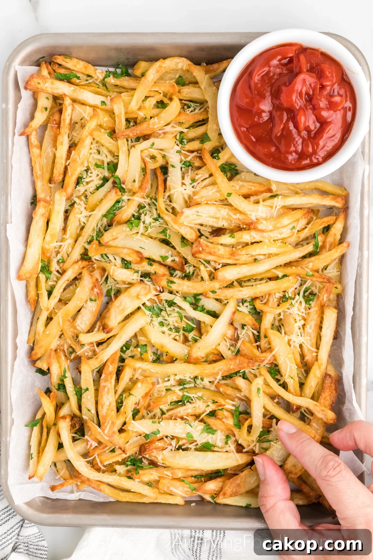 Crispy Air Fryer Truffle Fries Recipe 4 Truffle fries on a serving platter with a side of ketchup.