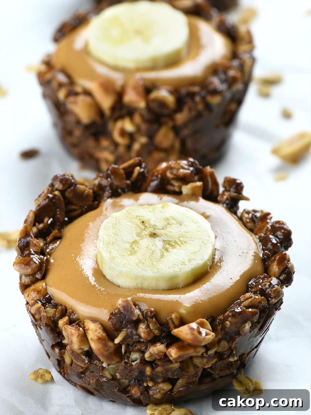 Chocolate Granola Cups with Peanut Butter Filling — No-Bake Treats 2 Chocolate Granola Cups filled with peanut butter and topped with banana slice.