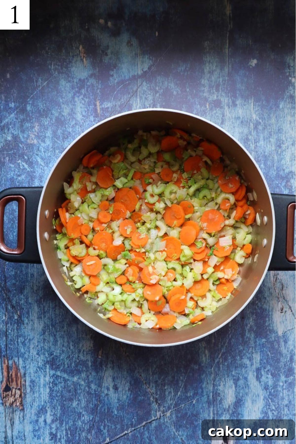 pot with sauteed carrots, celery, and onion.