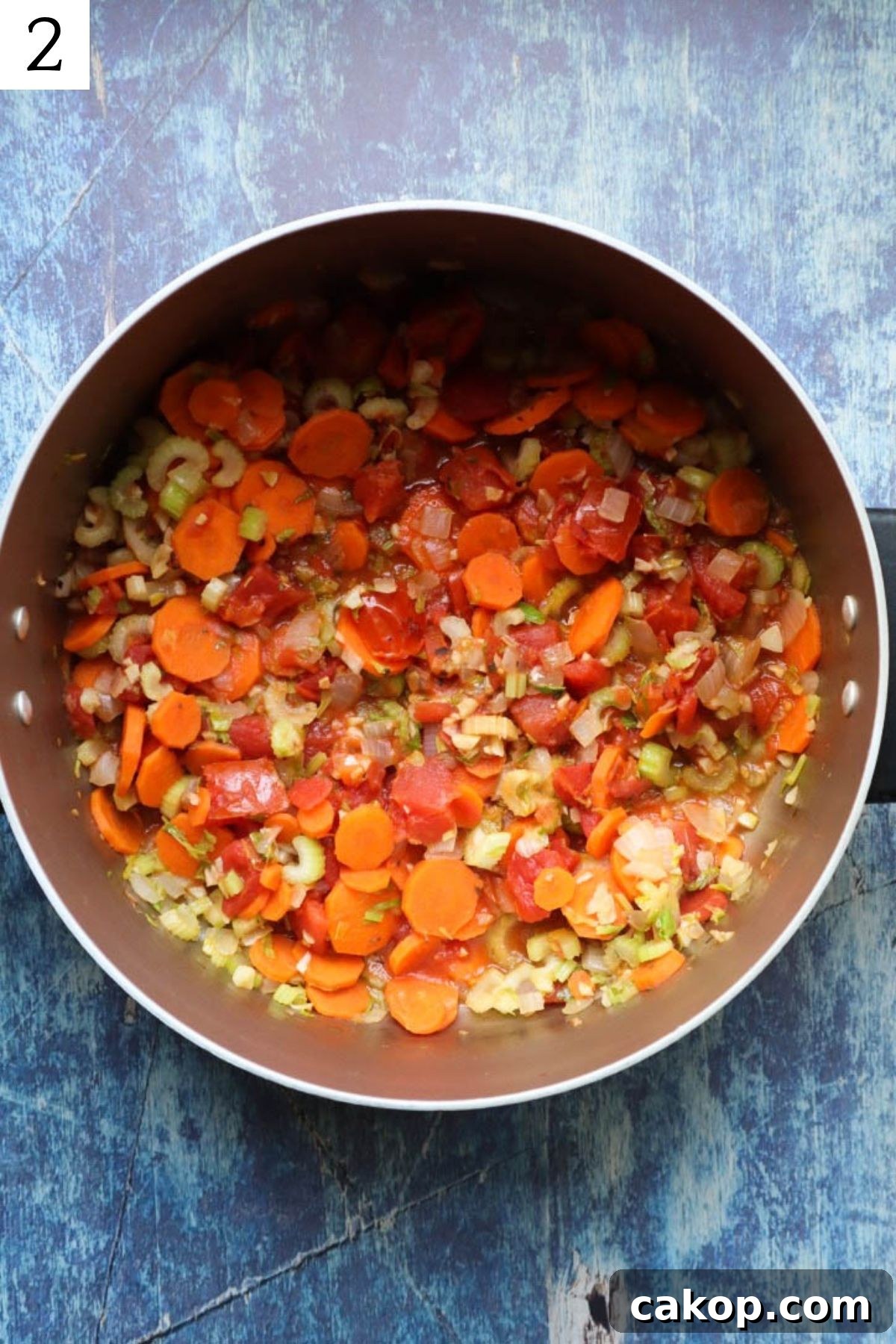 pot with sauteed vegetables and roasted tomatoes.