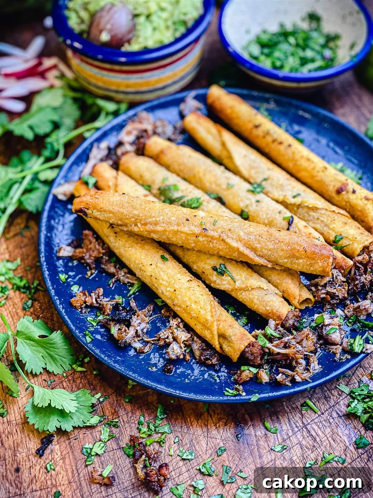 leftover carnitas taquitos on a blue plate