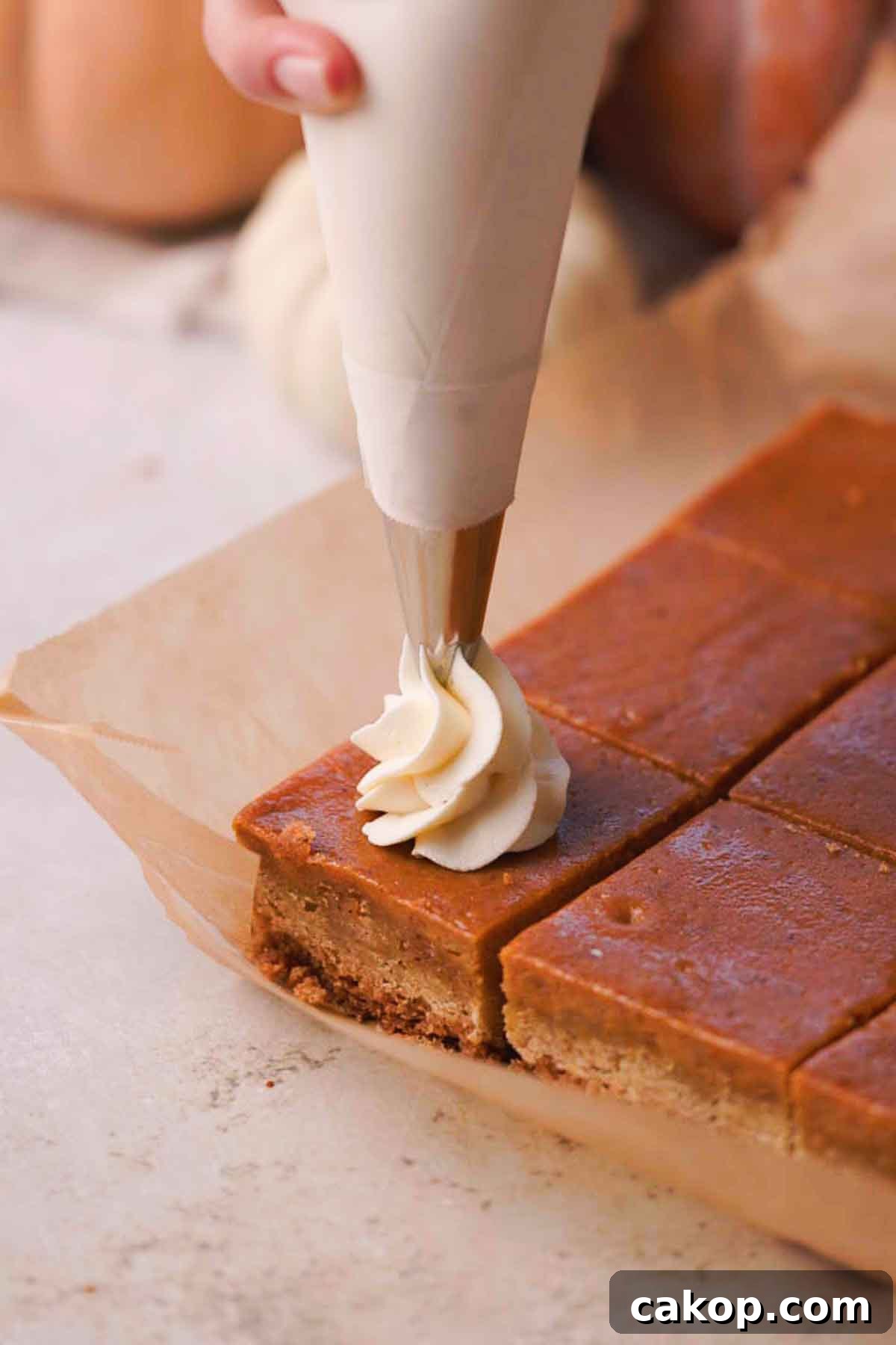 Creamy Pumpkin Pie Bars with Gingersnap Crust 15 piping whipped cream onto bars