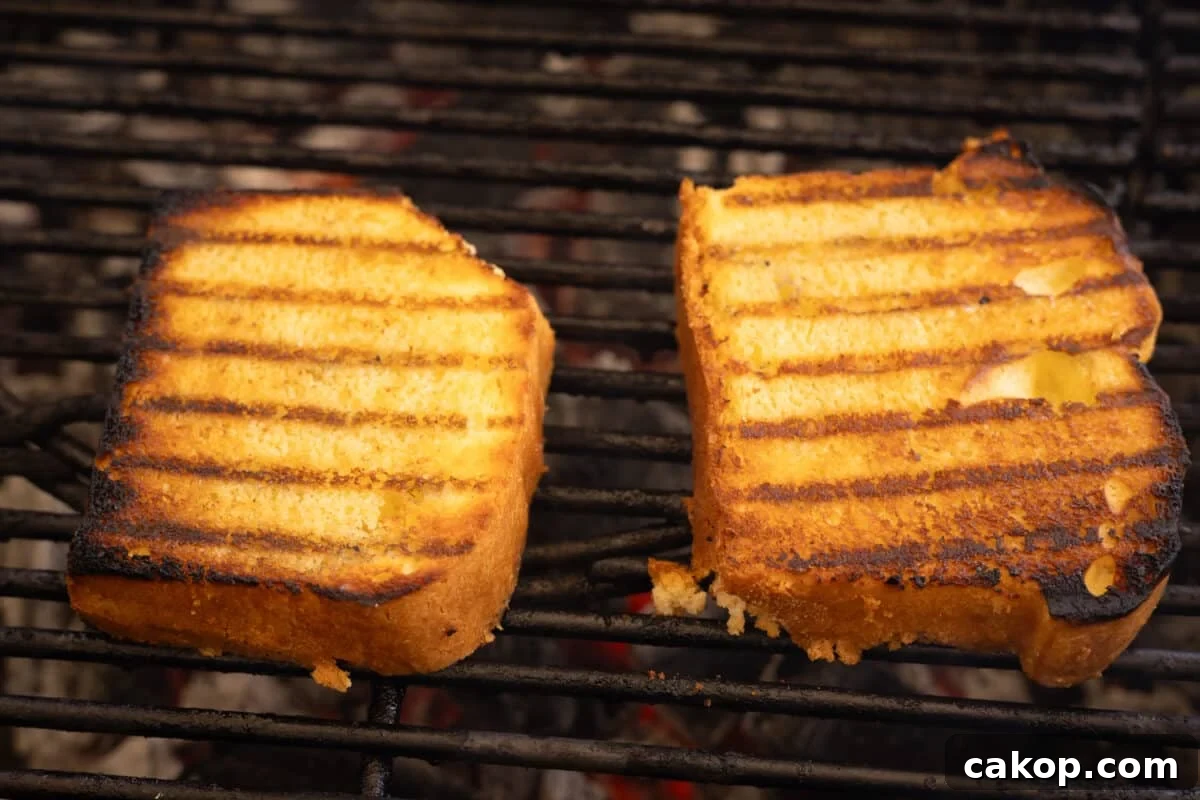 Grilled Pound Cake with Cinnamon-Smeared Peaches 4 Two slices of yellow cake on the grates of a grill.
