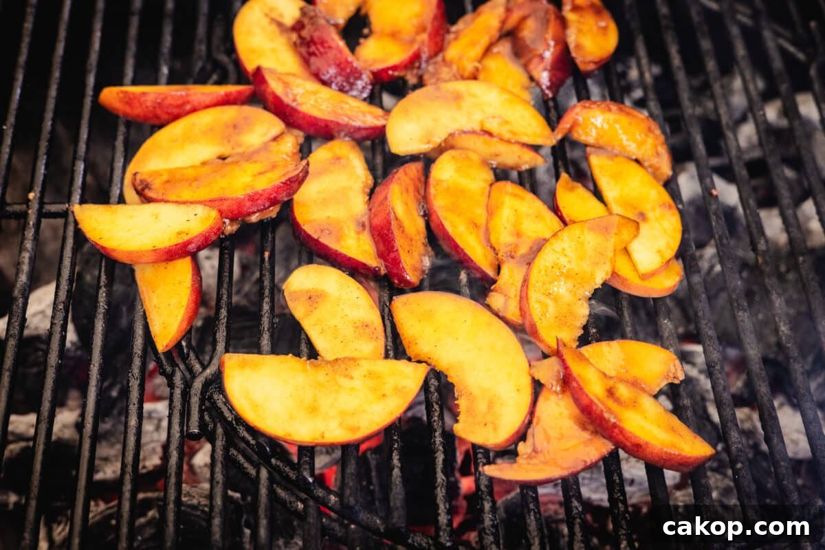 Grilled Pound Cake with Cinnamon-Smeared Peaches 5 Peach slices on the grates of a grill.
