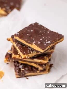 Stack of chocolate peanut butter date bark pieces showing layers of dates, peanut butter, peanuts, and chocolate