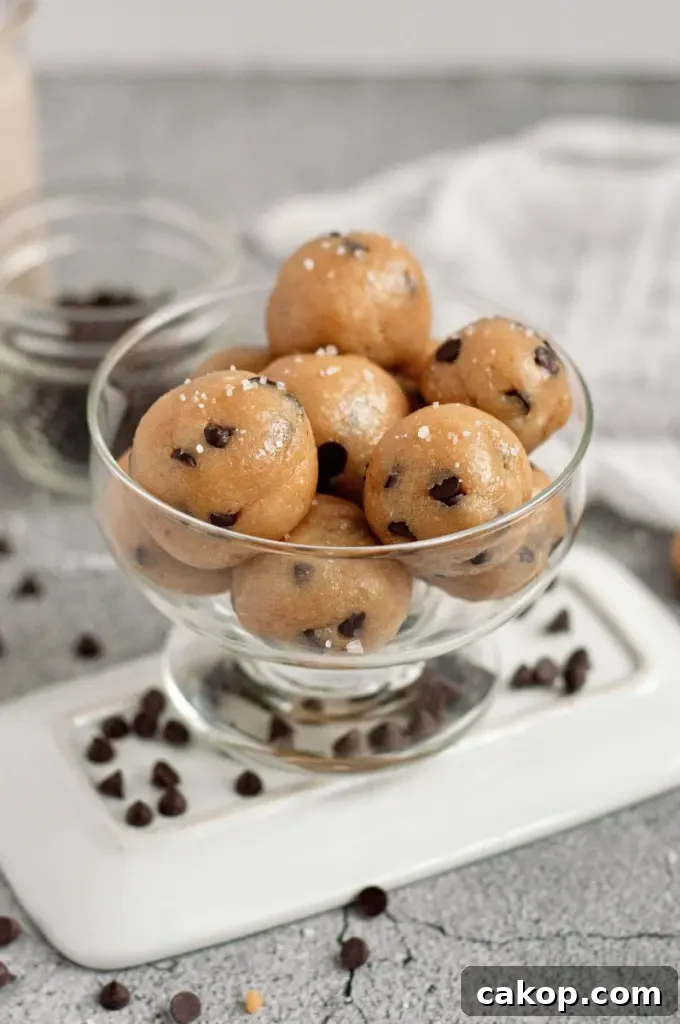 Golden brown cookie dough balls with dark chocolate chips sprinkled with coarse sea salt.