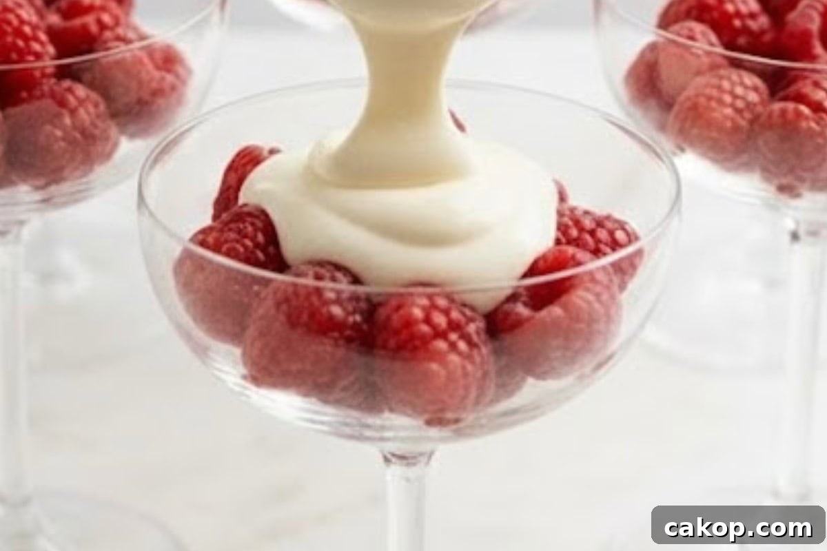 Divide 1 cup of raspberries across 6 small glasses, gently pressing them into the base. Spoon the cheesecake mixture over the berries