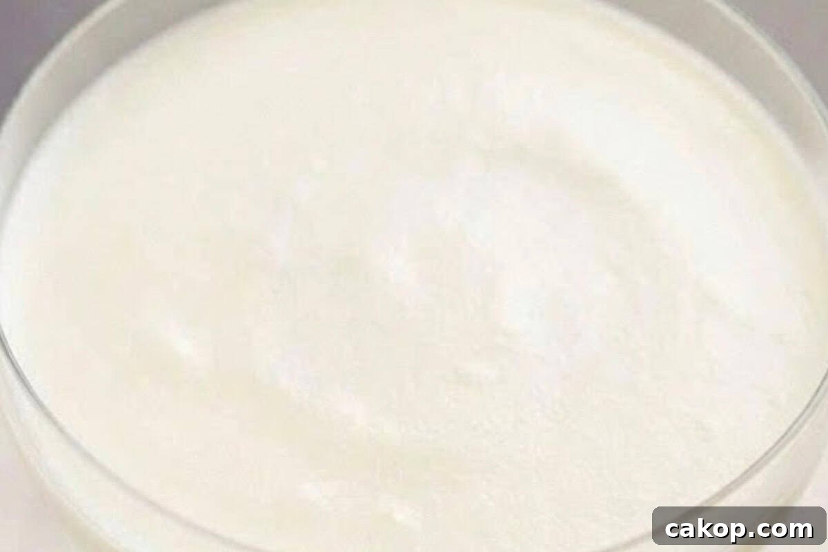 Remove glasses from the fridge and divide the whipped cream evenly over the cheesecake layer.