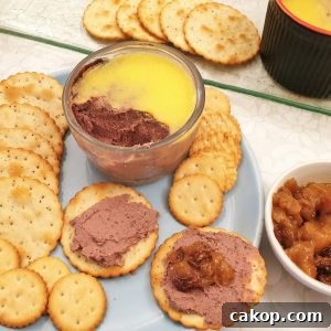 A dish of chicken liver pate with biscuits.