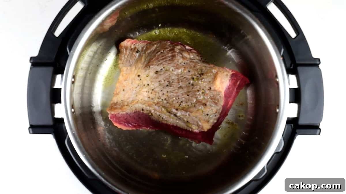 Instant Pot Beef Brisket with Garlic Smashed Potatoes 5 Searing brisket in an Instant Pot