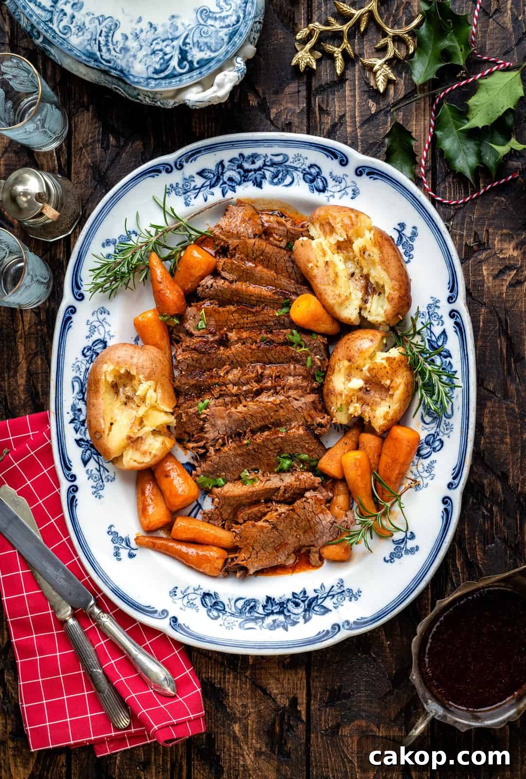 Instant Pot Beef Brisket with Garlic Smashed Potatoes 9 Close up of sliced balsamic beef brisket arranged on a blue platter with potatoes and carrots