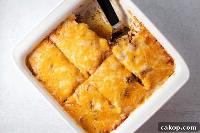 white casserole dish with keto taco casserole with one piece missing