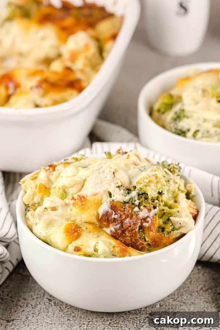 closeup of small white bowl containing a serving of keto chicken broccoli casserole