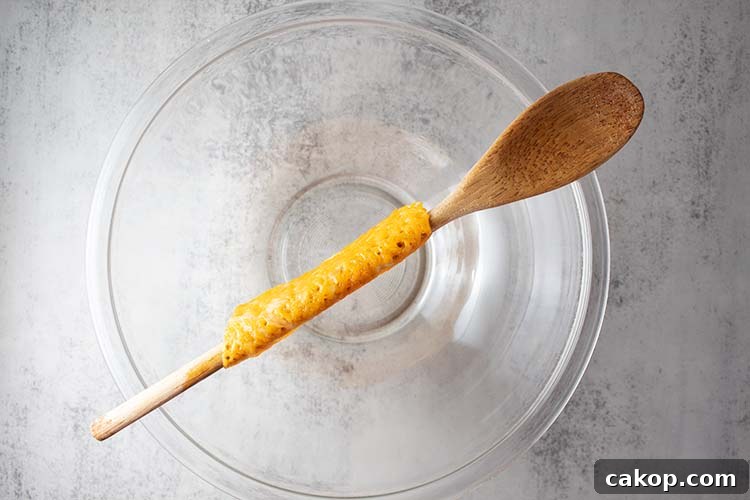 keto cheese shell draped over a wooden spoon