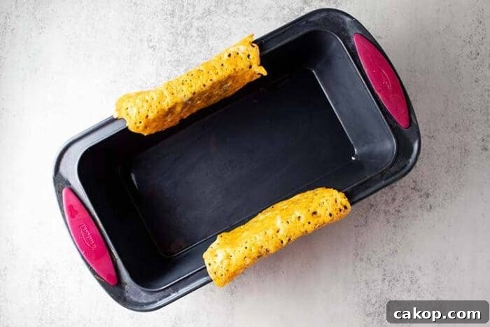 keto taco shells draped over the side of a loaf pan