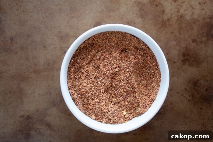 keto taco seasoning in a white bowl on a distressed serving tray