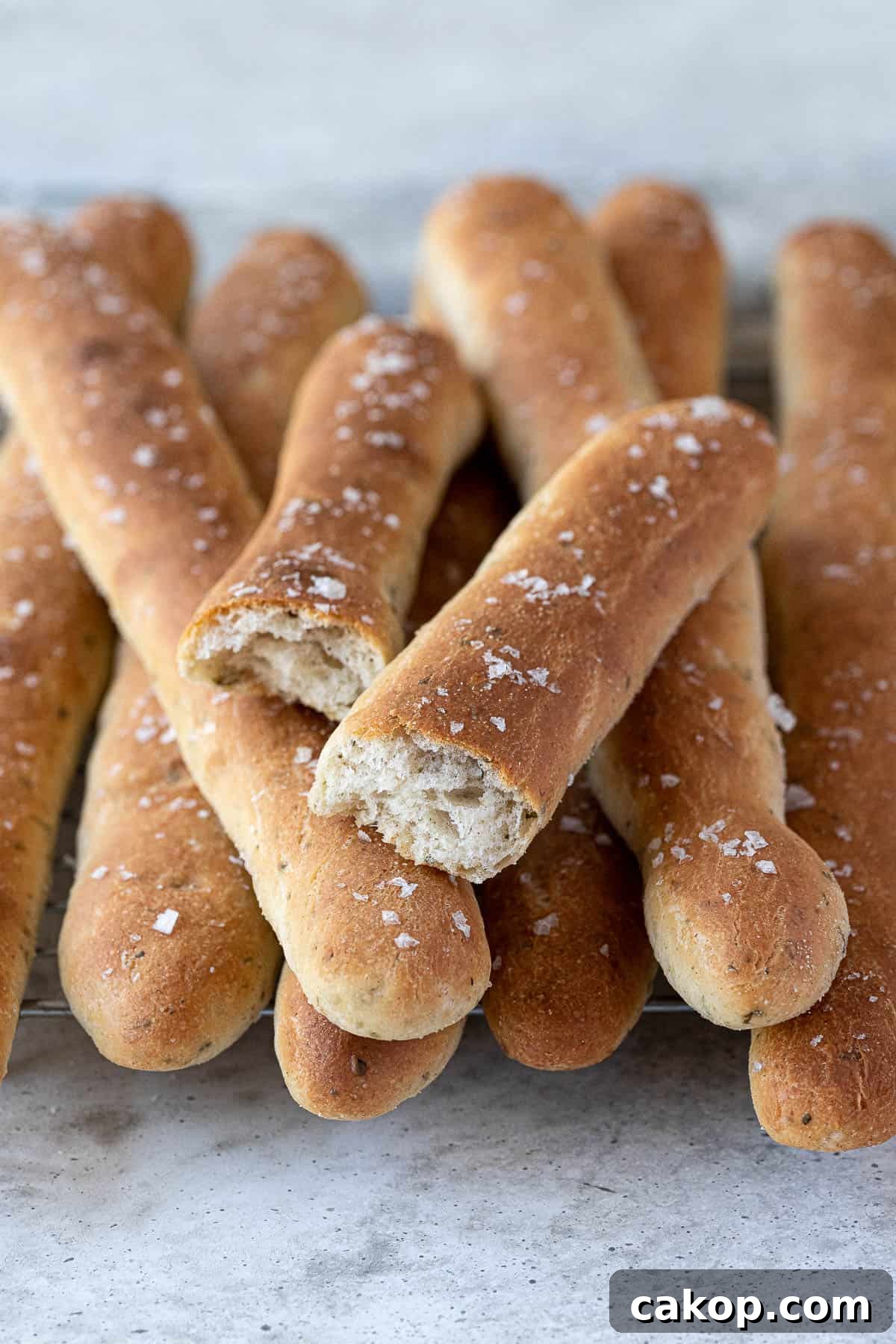 Close up of a breadstick broken in half.