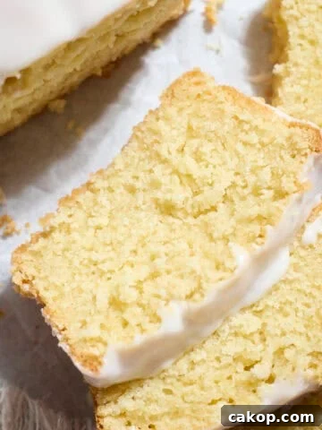 Slices of Sourdough Lemon Loaf Cake on white parchment paper.