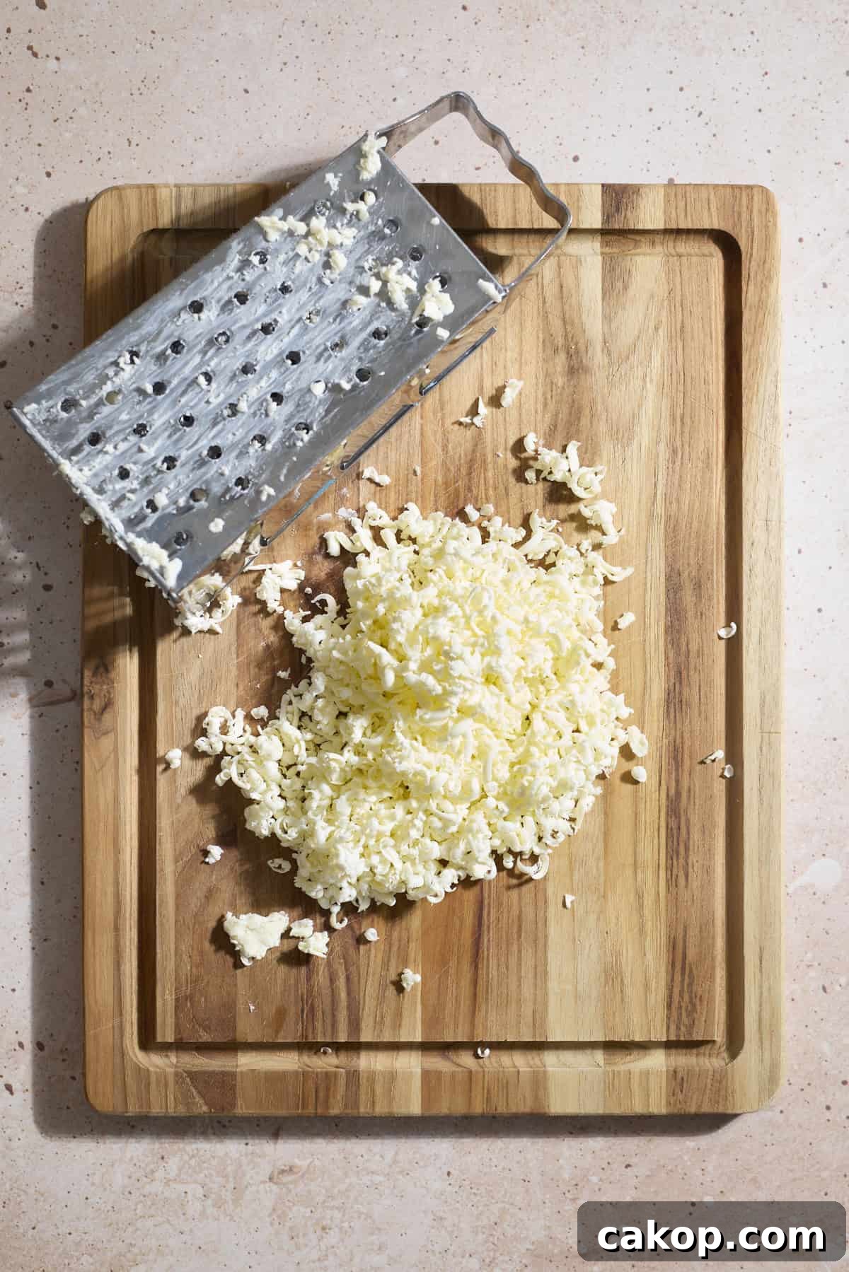 Sourdough Lemon Poppy Seed Scones Recipe for Tender, Tangy Bakes 6 Grated butter on a wooden cutting board.