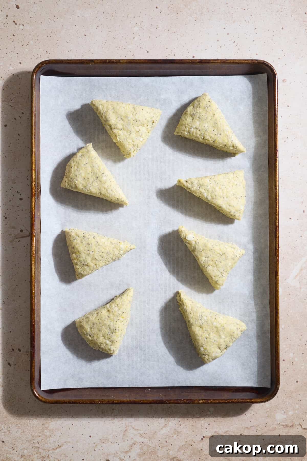 Sourdough Lemon Poppy Seed Scones Recipe for Tender, Tangy Bakes 9 Scones on a baking sheet.