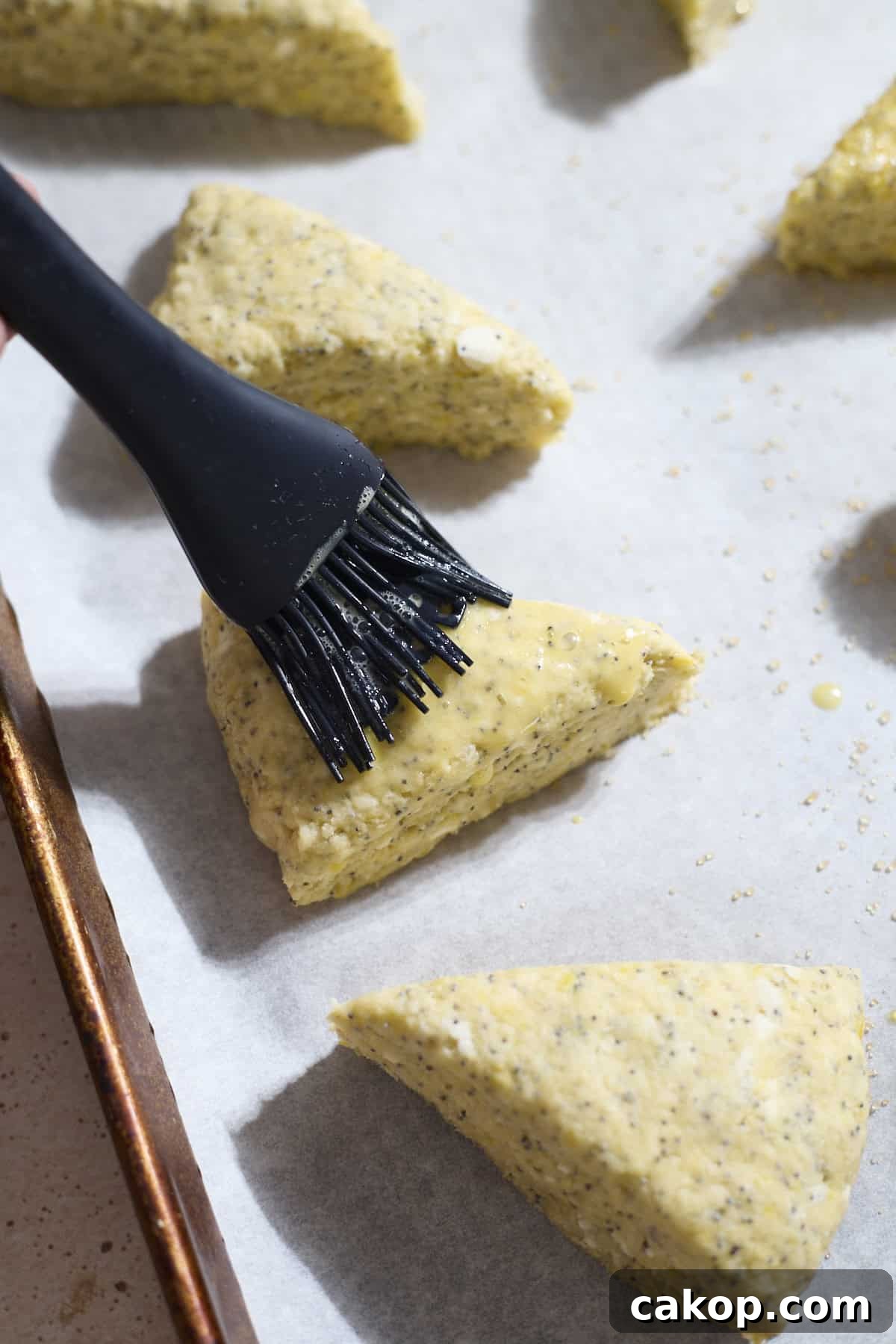 Sourdough Lemon Poppy Seed Scones Recipe for Tender, Tangy Bakes 10 Scones being brushed with egg wash.