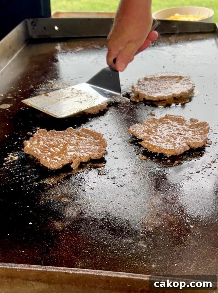 Guacamole Burger Recipe: Juicy Beef Patties with Fresh Avocado 4 Smashing burgers on blacktone griddle.