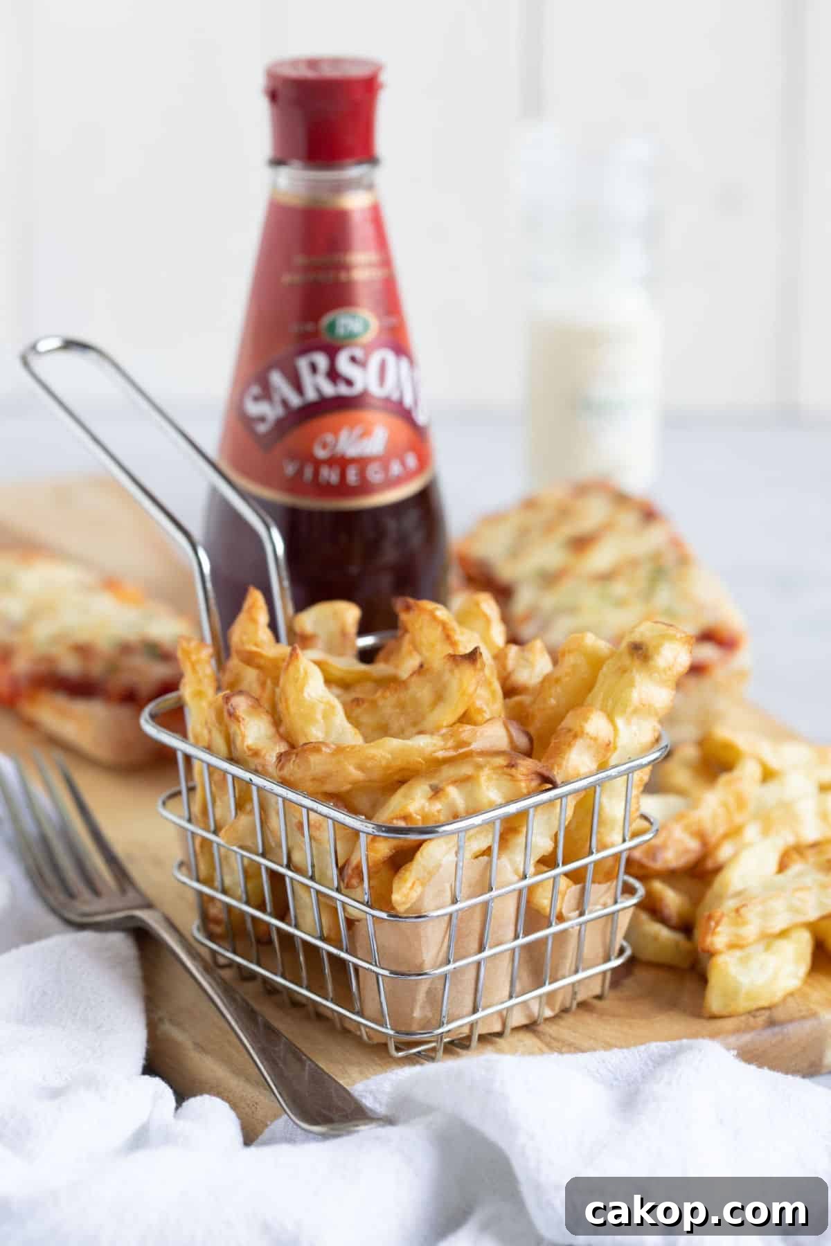 Air fryer chips in a wire basket.