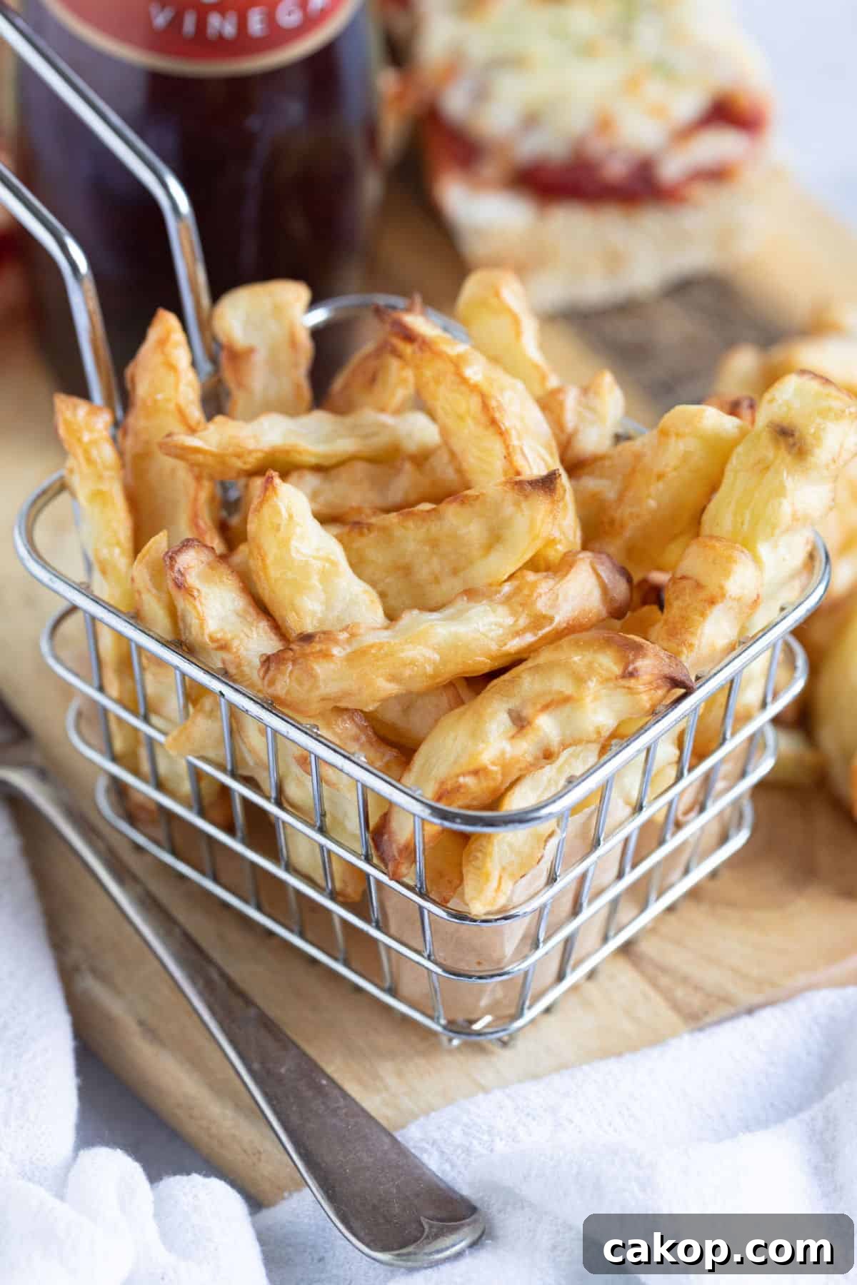 Air fryer chips in a wire basket.