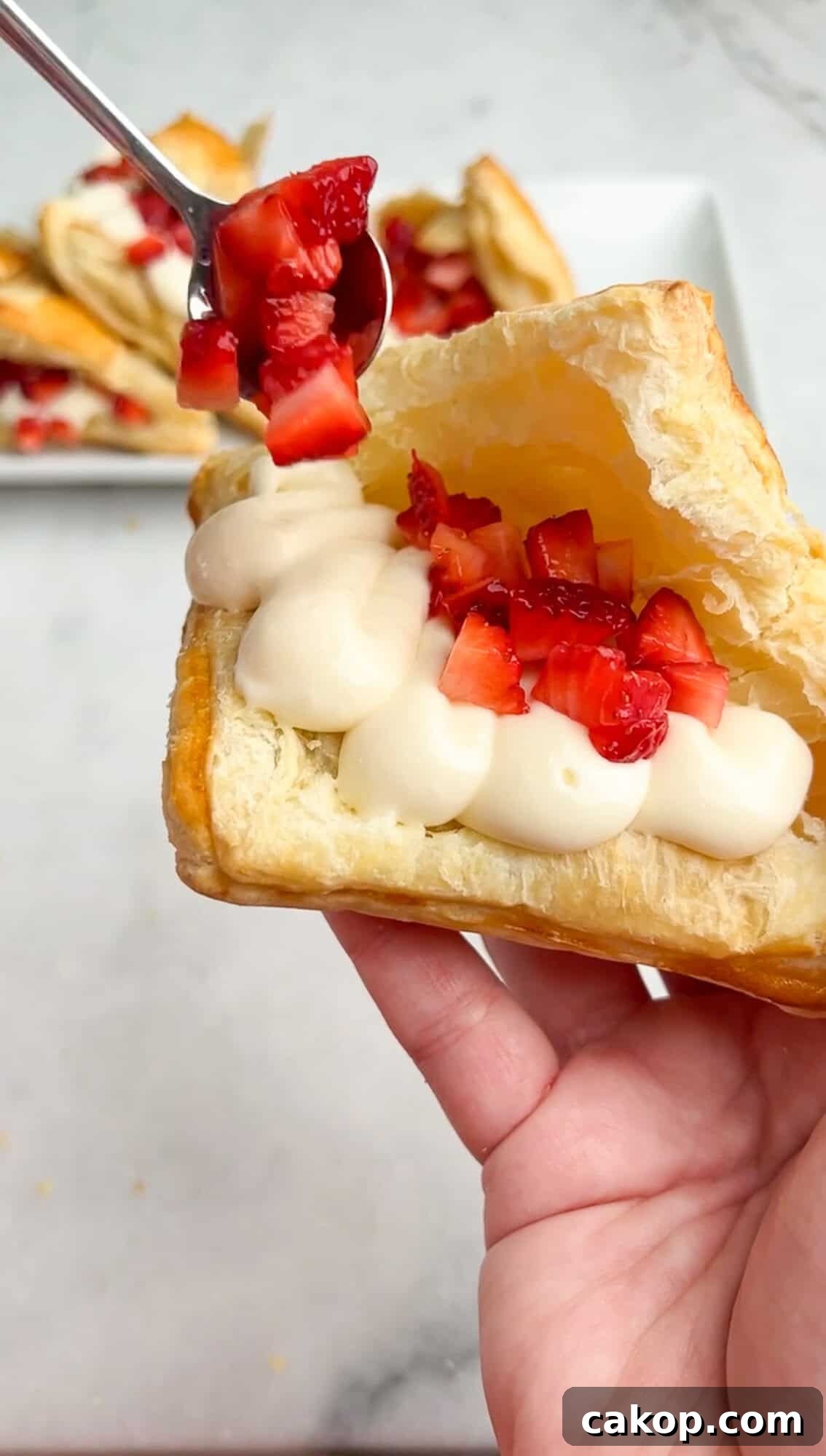 Strawberry Cheesecake Turnover Recipe — Flaky Pastry with Creamy Filling 11 adding strawberries into turnover pastries