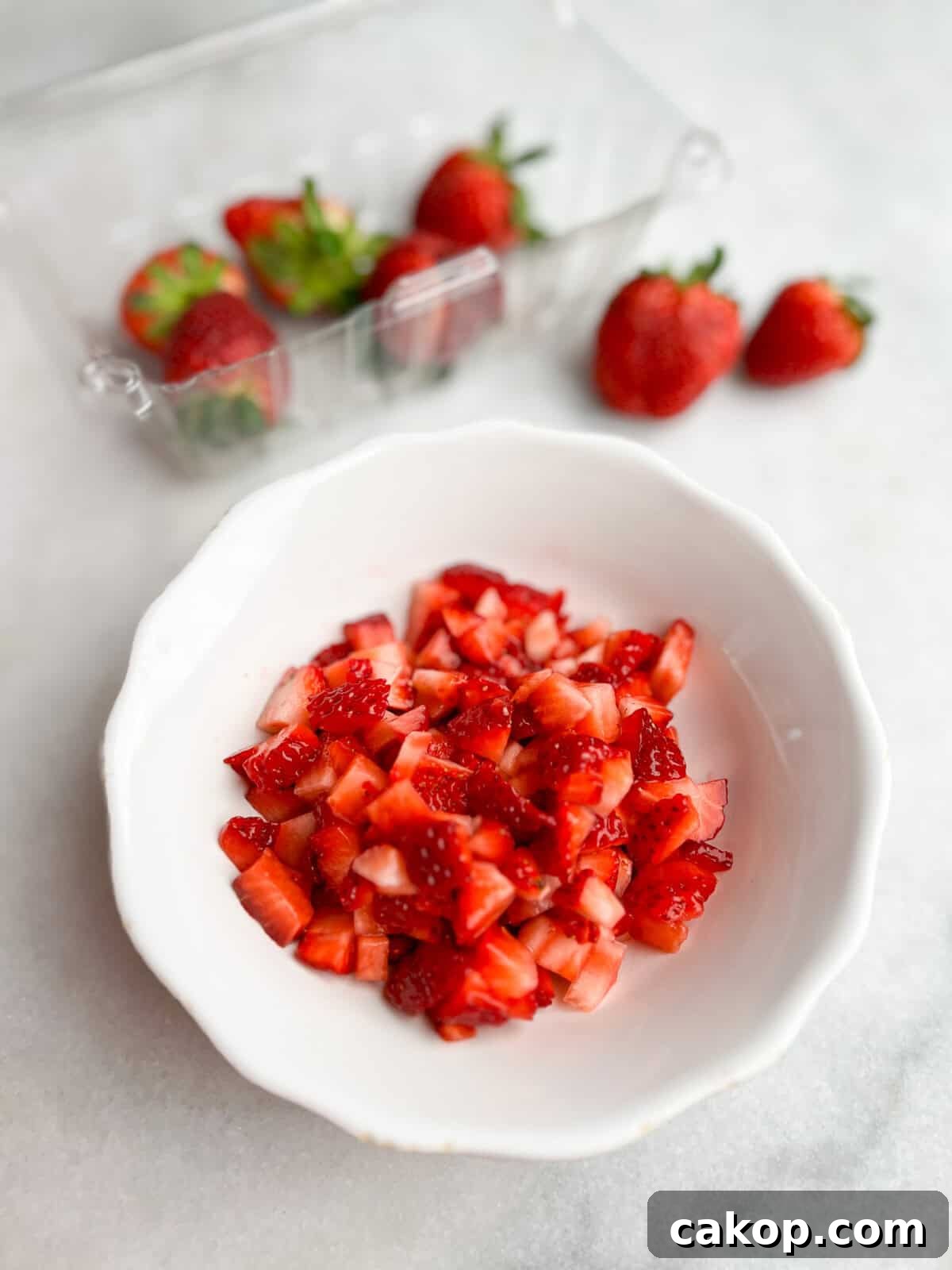 Strawberry Cheesecake Turnover Recipe — Flaky Pastry with Creamy Filling 4 diced strawberries on the counter