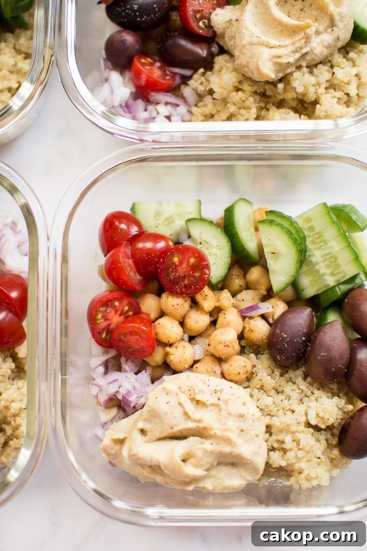 Mediterranean Vegan Meal Prep Bowls for Flavorful Weekly Lunches 4 close-up of glass container with cucumber, olives, tomatoes, chickpeas, hummus, and quinoa