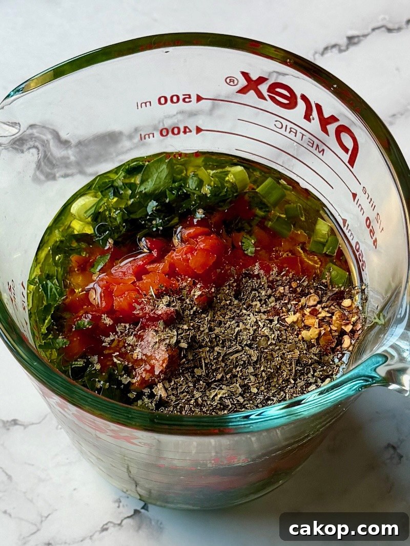 Mediterranean Marinated Cheese Bites for Party Appetizers 4 Marinade ingredients in a mixing bowl.