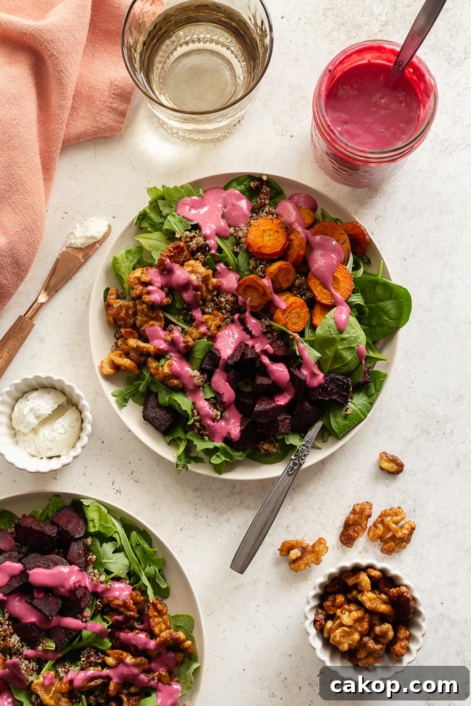 Roasted Beet and Carrot Salad arranged on plates and topped with cranberry salad dressing.