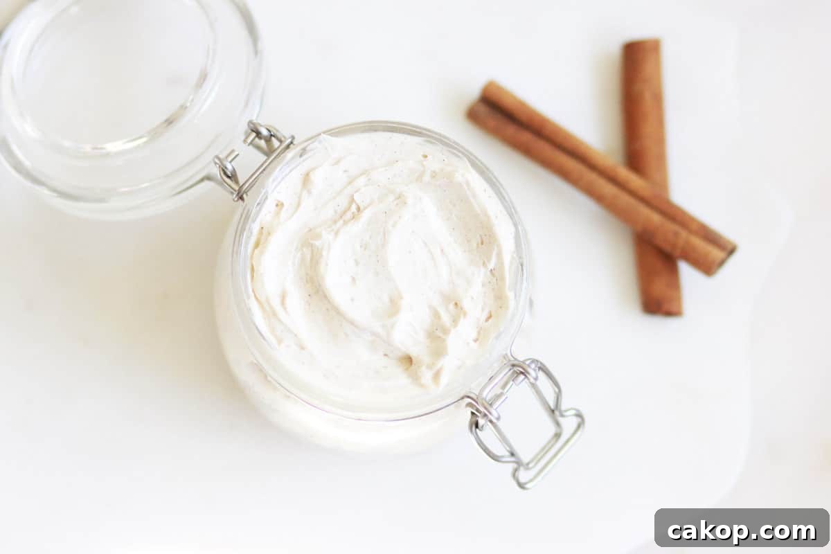 Whipped Gingerbread Body Butter: DIY Recipe for Silky Skin 4 a jar of whipped gingerbread body butter with cinnamon sticks next to it